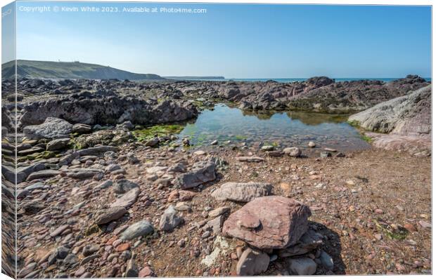 Calm rock pools on Freshwater West beach Pembrokeshire Canvas Print by Kevin White