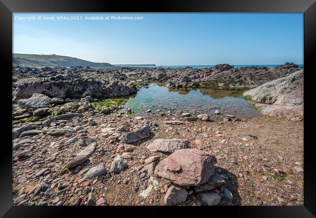 Calm rock pools on Freshwater West beach Pembrokeshire Framed Print by Kevin White