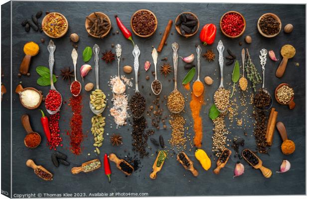 Colorful selection of exotic spices on a slate Canvas Print by Thomas Klee
