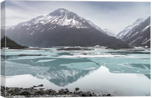 Snow covered mountains reflected between the ice sheets in Valdez Glacier Lake, Valdez, Alaska, USA Canvas Print by Dave Collins