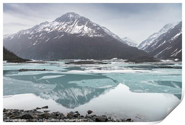 Snow covered mountains reflected between the ice sheets in Valdez Glacier Lake, Valdez, Alaska, USA Print by Dave Collins