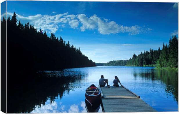 couple relaxing after canoeing Canvas Print by Dave Reede