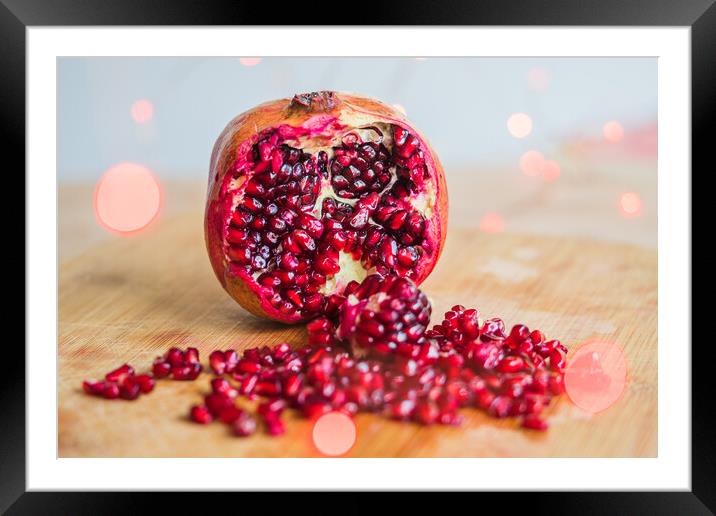 Pomegranate seeds amongst red lights Framed Mounted Print by Jason Wells