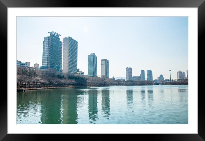 A body of water with a city in the background Framed Mounted Print by Ambir Tolang