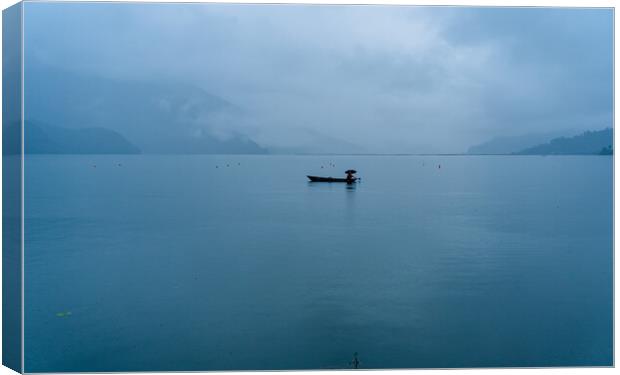 boatman fishing on phewa lake Canvas Print by Ambir Tolang
