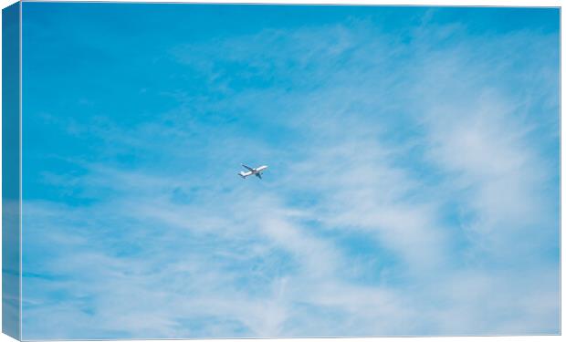aircraft flying through a cloudy blue sky Canvas Print by Ambir Tolang