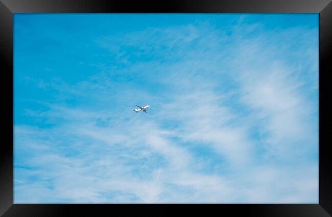 aircraft flying through a cloudy blue sky Framed Print by Ambir Tolang