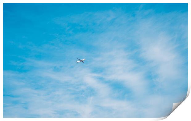 aircraft flying through a cloudy blue sky Print by Ambir Tolang
