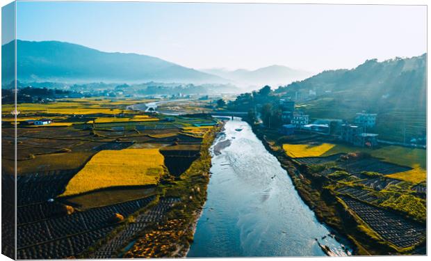 aerial view of paddy farm field and river with a mountain Canvas Print by Ambir Tolang