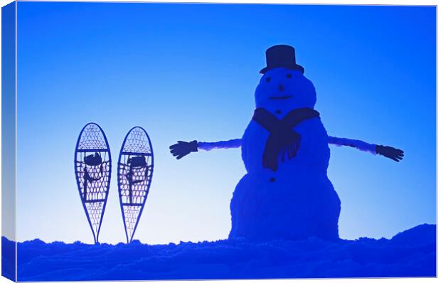snowman  beside snowshoes Canvas Print by Dave Reede