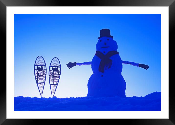 snowman  beside snowshoes Framed Mounted Print by Dave Reede