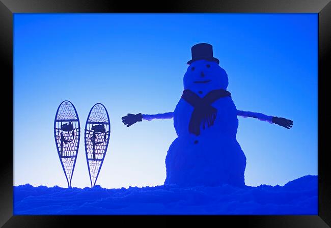 snowman  beside snowshoes Framed Print by Dave Reede