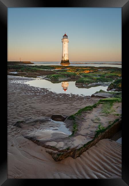 Lighthouse on the Rocks Framed Print by Liam Neon