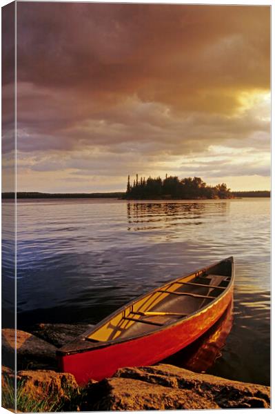 canoe on Nutimik Lake Canvas Print by Dave Reede