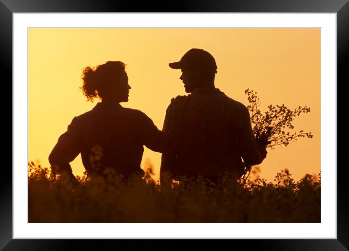 couple in bloom stage canola field Framed Mounted Print by Dave Reede