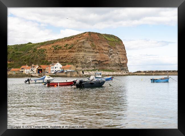 Commercial fishing boats moored in Staithes harbour on the North Yorkshire coast Framed Print by Chris Yaxley