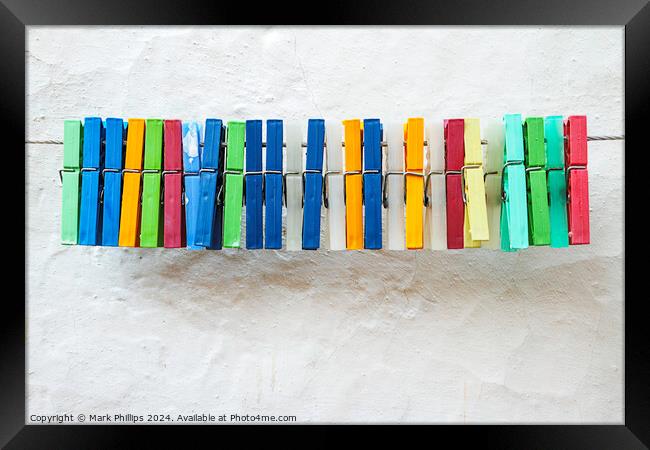 Clothes peg colours Framed Print by Mark Phillips