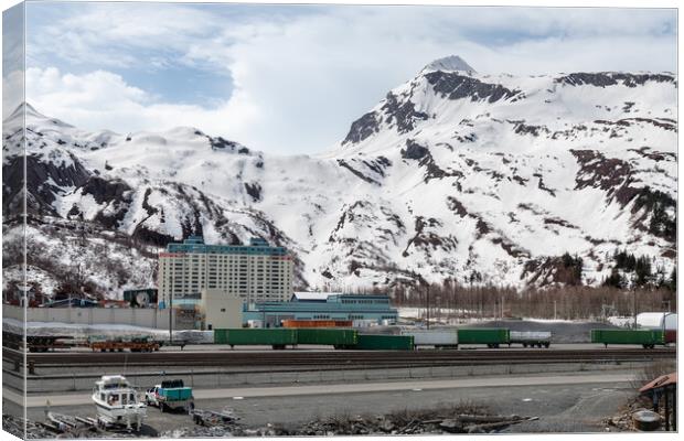 The Begich Towers Condominium building and snow covered mountains behind, Whittier, Alaska, USA Canvas Print by Dave Collins