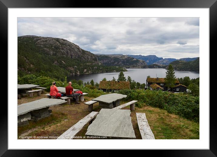 A couple relaxes at Preikestolen Base Camp with a view of Lake R Framed Mounted Print by Andreas Himmler