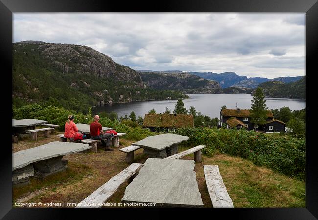 A couple relaxes at Preikestolen Base Camp with a view of Lake R Framed Print by Andreas Himmler