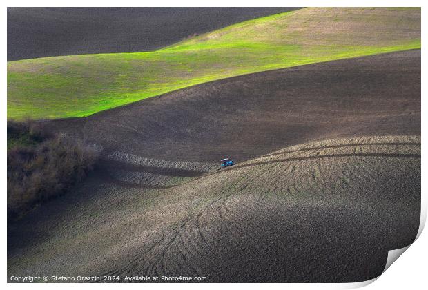 Tractor plowing the fields in Tuscany. Volterra, Italy Print by Stefano Orazzini