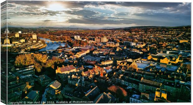 Aerial view of a city Lancaster at sunset with warm lighting, highlighting the urban landscape and river. Canvas Print by Man And Life