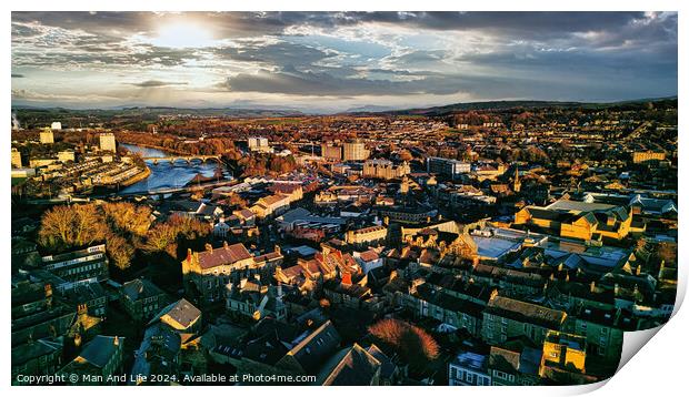 Aerial view of a city Lancaster at sunset with warm lighting, highlighting the urban landscape and river. Print by Man And Life