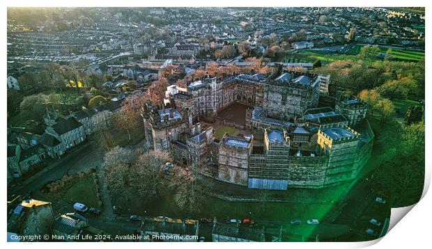 Aerial view of a historic Lancaster castle at sunset with surrounding greenery and urban backdrop. Print by Man And Life