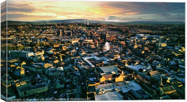 Aerial view of a city Lancaster at sunset with warm lighting, showcasing urban architecture and a distant horizon under a colorful sky. Canvas Print by Man And Life