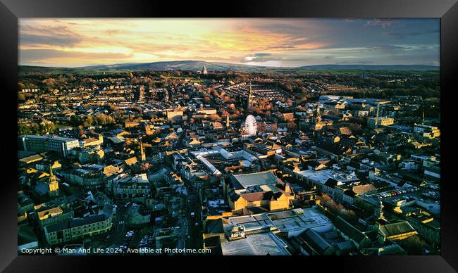 Aerial view of a city Lancaster at sunset with warm lighting, showcasing urban architecture and a distant horizon under a colorful sky. Framed Print by Man And Life