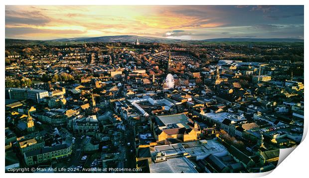 Aerial view of a city Lancaster at sunset with warm lighting, showcasing urban architecture and a distant horizon under a colorful sky. Print by Man And Life
