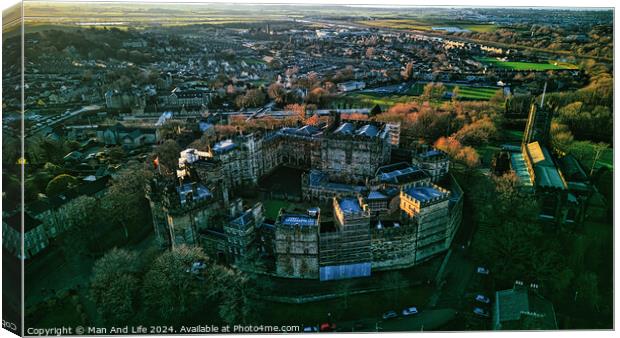Aerial view of a historic Lancaster castle at sunset with surrounding cityscape and greenery. Canvas Print by Man And Life