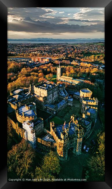 Aerial view of a historic Lancaster castle at sunset with surrounding gardens and distant cityscape. Framed Print by Man And Life