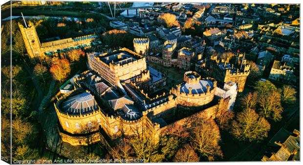 Aerial view of a majestic medieval Lancaster castle at sunset, with surrounding greenery and town in the background. Canvas Print by Man And Life
