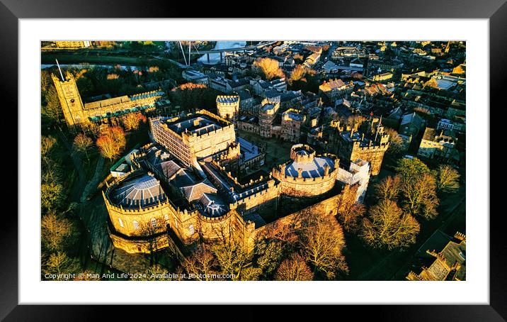 Aerial view of a majestic medieval Lancaster castle at sunset, with surrounding greenery and town in the background. Framed Mounted Print by Man And Life