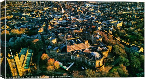 Aerial view of a historic Lancaster castle amidst a sprawling cityscape during golden hour, showcasing architectural beauty and urban density. Canvas Print by Man And Life