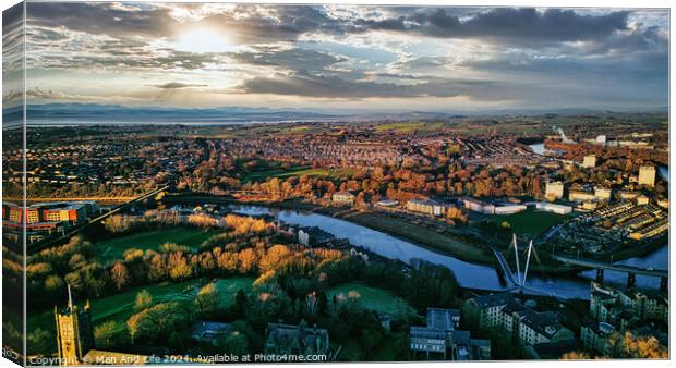 Aerial view of Lancaster city at sunset with a river flowing through, highlighting the urban landscape and green spaces under a dramatic sky. Canvas Print by Man And Life