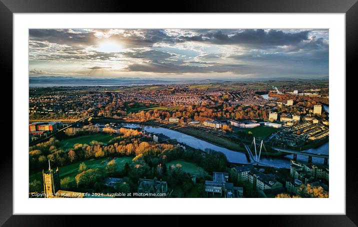 Aerial view of Lancaster city at sunset with a river flowing through, highlighting the urban landscape and green spaces under a dramatic sky. Framed Mounted Print by Man And Life