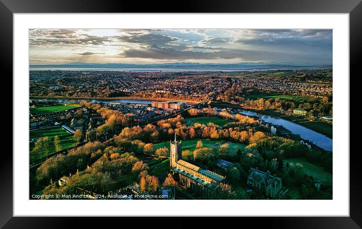 Aerial view of a cityscape at sunset with a prominent cathedral, lush green parks, and a river reflecting the warm sky in Lancaster. Framed Mounted Print by Man And Life