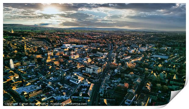 Aerial view of the Lancaster city at sunset with warm light casting over buildings and streets, showcasing urban landscape and architecture. Print by Man And Life