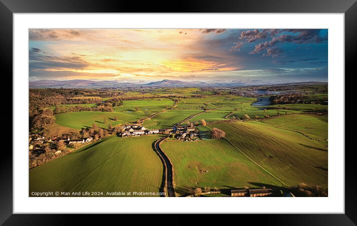 Aerial view of a picturesque village amidst green fields during sunset with a vibrant sky and a meandering river. Framed Mounted Print by Man And Life