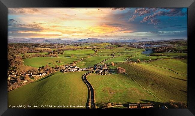 Aerial view of a picturesque village amidst green fields during sunset with a vibrant sky and a meandering river. Framed Print by Man And Life