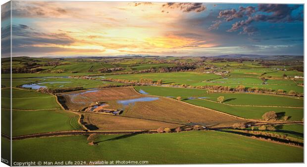 Aerial view of a picturesque rural landscape at sunset with vibrant skies, patchwork fields, and a network of country roads. Canvas Print by Man And Life