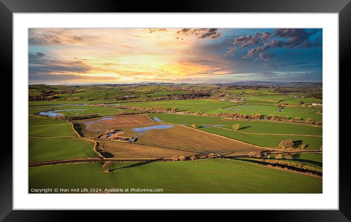 Aerial view of a picturesque rural landscape at sunset with vibrant skies, patchwork fields, and a network of country roads. Framed Mounted Print by Man And Life