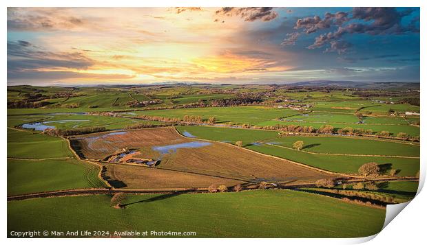 Aerial view of a picturesque rural landscape at sunset with vibrant skies, patchwork fields, and a network of country roads. Print by Man And Life