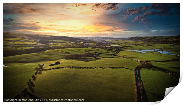 Aerial view of a lush green countryside at sunset with rolling hills, fields, and a winding river. Print by Man And Life