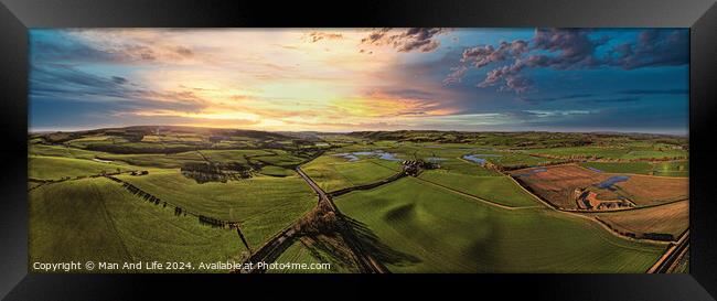 Panoramic view of a lush countryside at sunset with vibrant skies and rolling hills. Framed Print by Man And Life