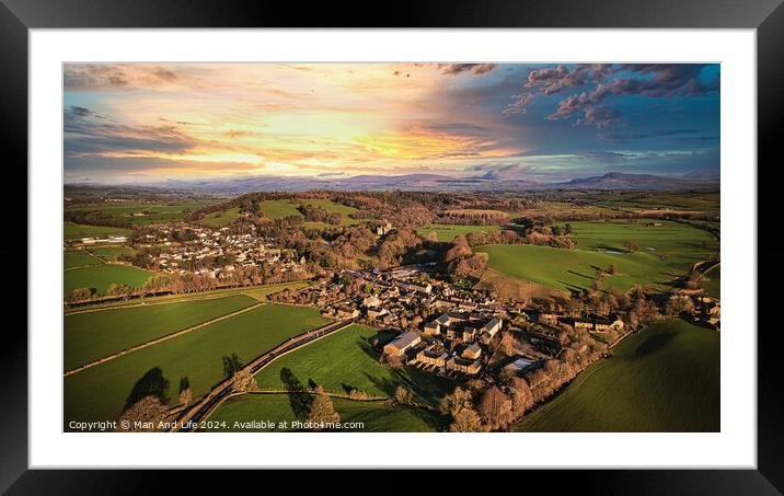 Aerial view of a quaint village amidst green fields during sunset with dramatic clouds. Framed Mounted Print by Man And Life