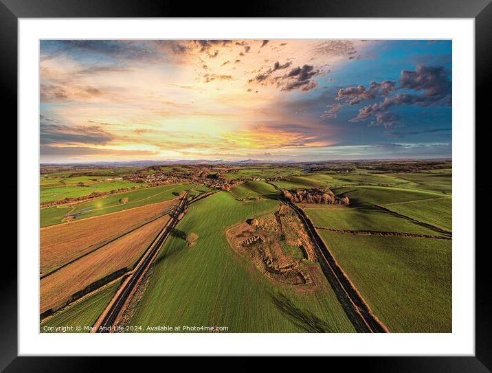 Aerial view of a lush countryside at sunset with vibrant skies and patchwork fields. Framed Mounted Print by Man And Life