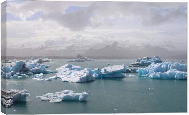 Iceland, Jokulsarlon Lagoon, Turquoise icebergs floating in Glacier Lagoon on Iceland. Canvas Print by Michael Piepgras